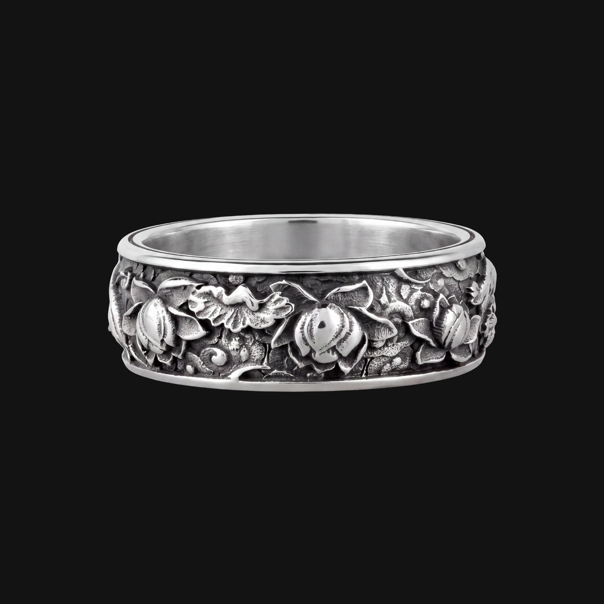 Silver flower ring on a dark background